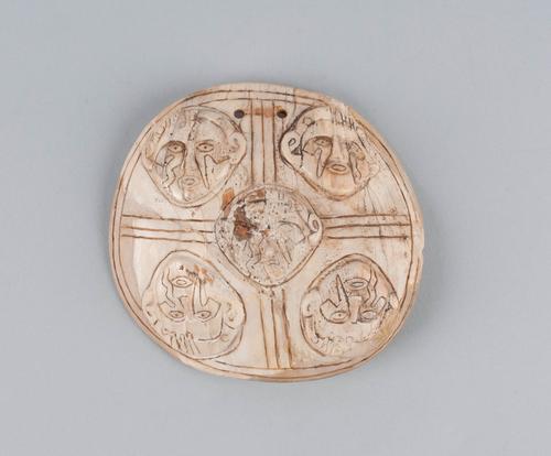Engraved gorget with human head effigies in relief